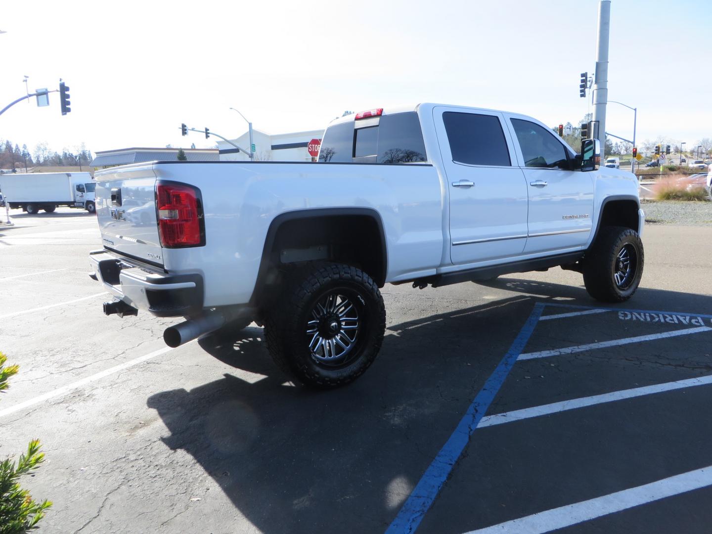 2015 White GMC Sierra 2500 HD Crew Cab Denali (1GT120E88FF) with an V8 Turbo Dsl 6.6L engine, Auto 6-Spd Allison OD transmission, located at 2630 Grass Valley Highway, Auburn, CA, 95603, (530) 508-5100, 38.937893, -121.095482 - 2015 GMC Denali 2500 6.6L Duramax Diesel. Cognito 4-6" lift kit, Cognito traction bars, Cognito idler and pitman support, Kryptonite upper control arms, Fox remote reservoir shocks, Amp power steps, Fuel Offroad wheels, Nitto Ridge Grappler tires, Alpine Stereo Firestone ride rite air bags, Transfer - Photo#4